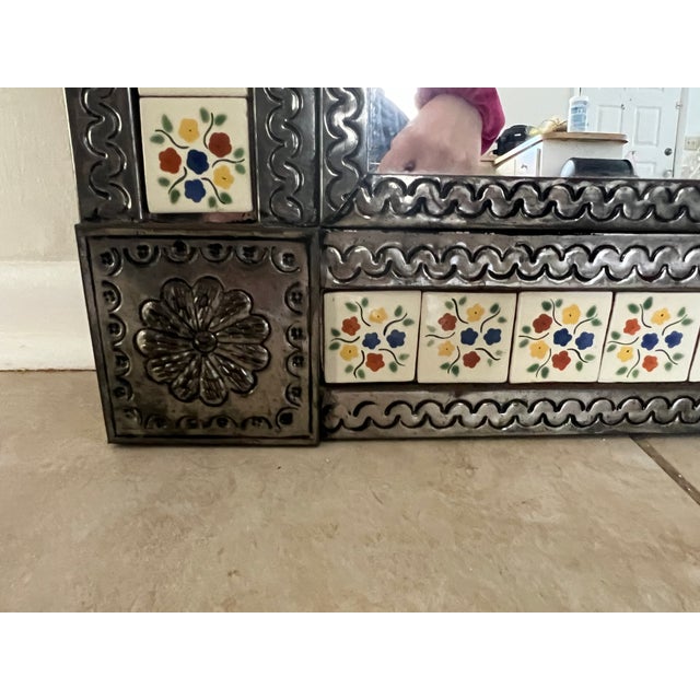 Unique vintage 1970s Mexican tin mirror! Each corner has a large flower design as part of the tin frame. The tiles are...