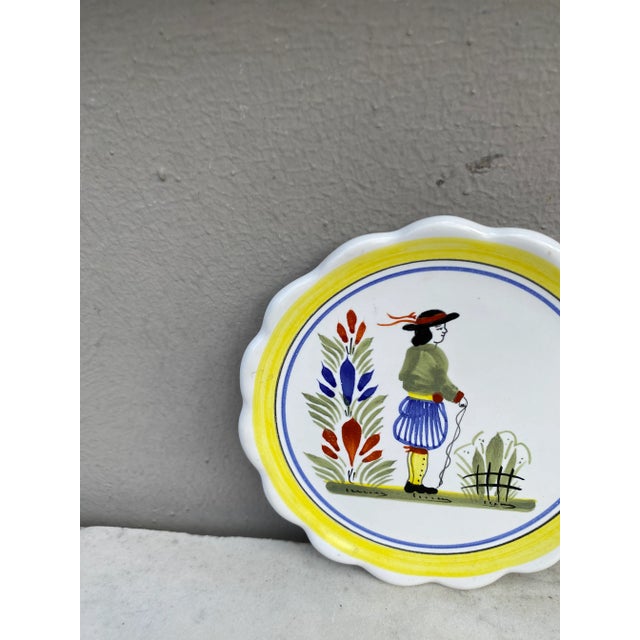French Miniature Henriot Quimper Plate signed circa 1950. A breton man is represented on the center with a yellow border.