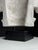 Plaster capital in Ionic style. Originating from England, late 20th century. Very decorative. On a custom black plinth....