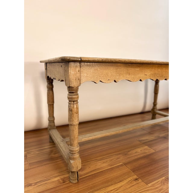 Late 19th century French draper’s table handcrafted from solid oak. Featuring a long plank top, open lower rail, and...