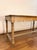 Late 19th century French draper’s table handcrafted from solid oak. Featuring a long plank top, open lower rail, and...