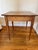 The French Louis Phillipe mixed wood diminutive baking table having a square walnut top over the conforming tiger maple...