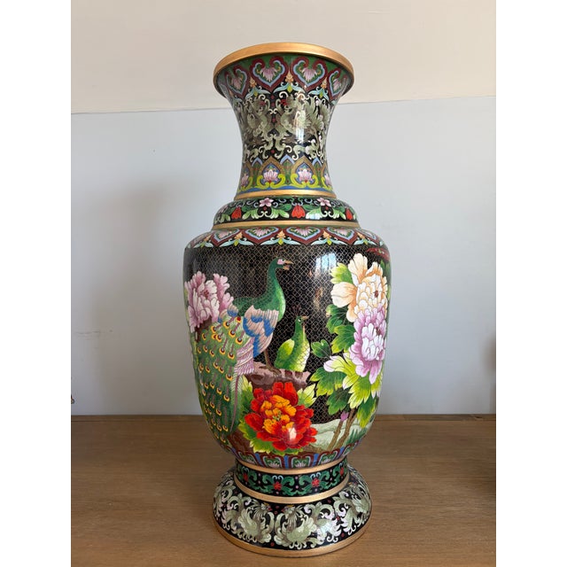 Large Chinese cloisonné enamel floor vase featuring a dramatic phoenix-and-floral design against a black background. The...