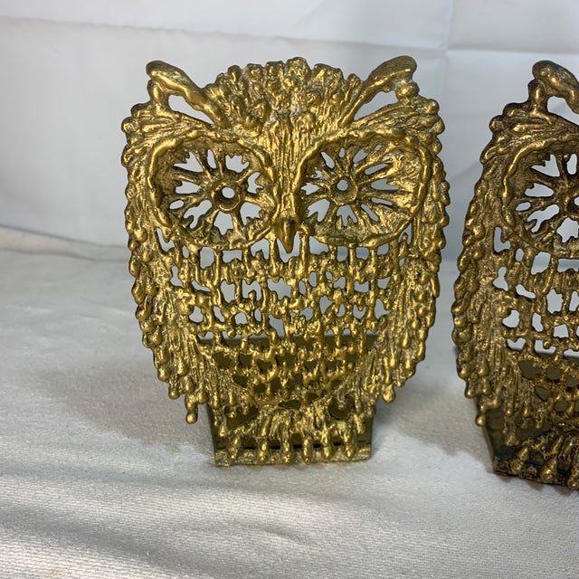 These vintage solid brass owl bookends feature a detailed, openwork filigree design representing wisdom and mid-century...