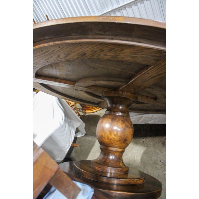 This impressive six-foot round dining table showcases exceptional craftsmanship with its substantial pedestal base and...