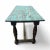 This entry or dining table features a rustic design with turned wooden legs and a distressed turquoise-painted top,...