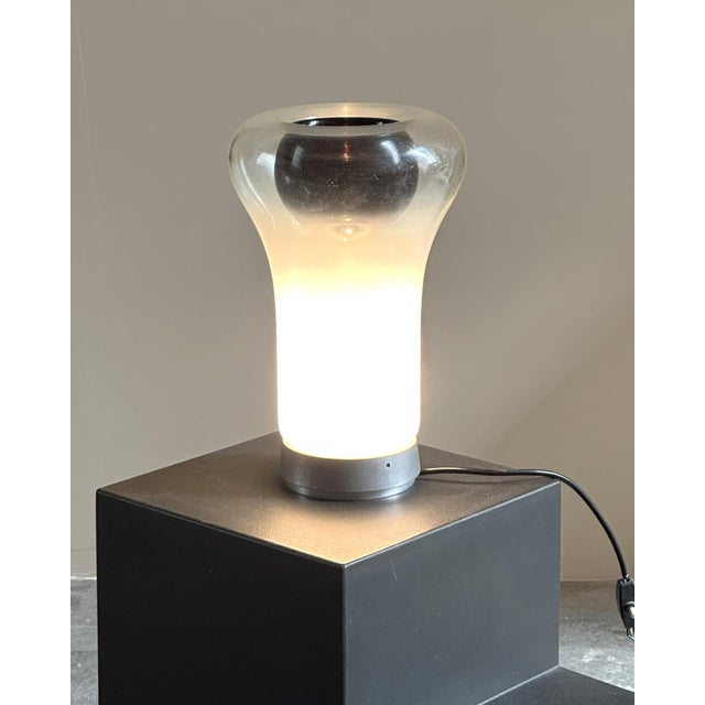 "Saffo" table lamp designed by Angelo Mangiarotti for Artemide, circa 1960s. Round aluminum base with opal blown glass...
