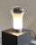 "Saffo" table lamp designed by Angelo Mangiarotti for Artemide, circa 1960s. Round aluminum base with opal blown glass...