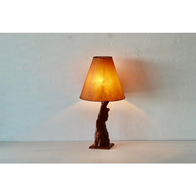 A vintage mid-century cypress knee (or burl wood) sculptural table lamp paired with a rustic textured paper shade. Crafted...