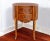 A bowed front with center double drawers decorated with parquet inlay and original brass pulls supported by a scalloped...