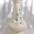 This is a Belleek eight inch island vase in the Shamrock pattern from 1946. The vase is off white with green leaves and a...