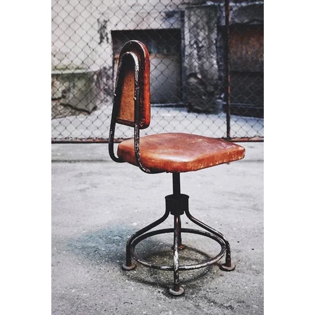 This leather swivel chair from the 1930s was imported from the United States and features a solid metal base integrated...
