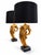 A striking pair of sculptural table lamps featuring sweeping, leaf-inspired forms in a warm gold finish. Each lamp rests...