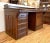 Antique clerk's desk made of quarter sawn oak in a dark finish and intricately carve corbels on each side. It features...