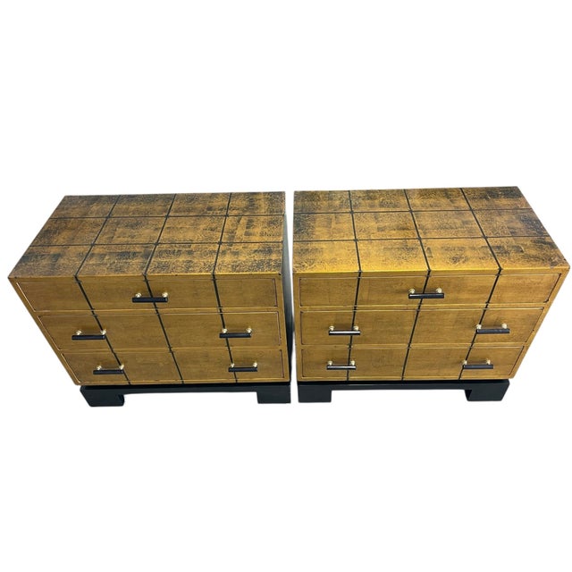 Bold and sophisticated pair of vintage gilt low chests or nightstands featuring a hand-applied gold finish with graphic...