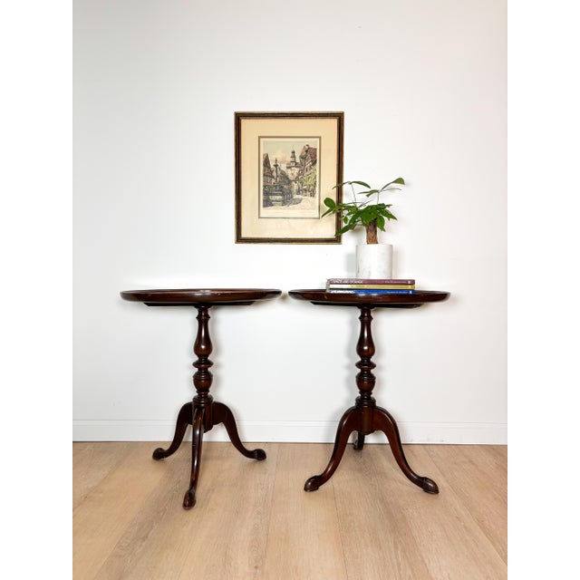 Add a touch of timeless Federal style elegance to your home with this handsome pair of vintage mahogany pedestal tables by...