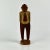 This was acquired in France. A vintage folk art wood carving of a man with yellow shirt, red tie and pants. He's standing...