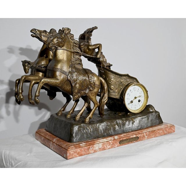 Clock with winding mechanism in regula, with a golden patina, by the French sculptor Xavier Raphanel (1876-1957). Knight...