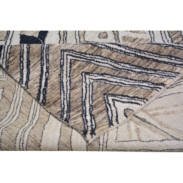 Hand-knotted with care using traditional rug making techniques, this wool rug blends timeless craftsmanship with a modern...