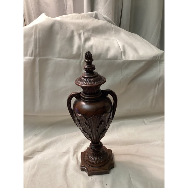This urn features intricate details, including leaf – like patterns(ACANTHUS) leaves and a decorative finial on the lid....