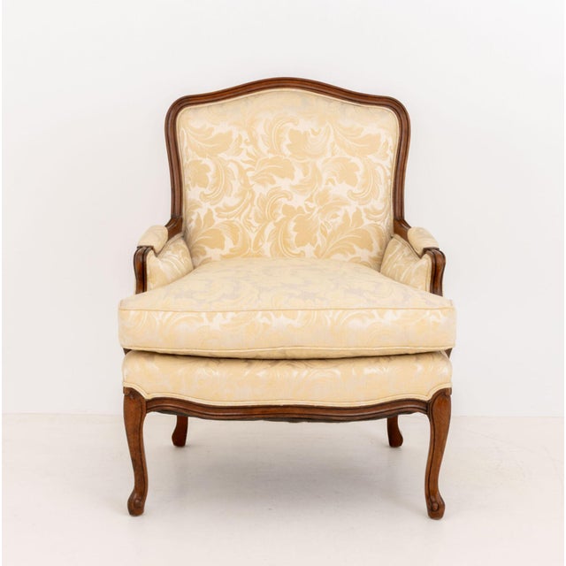 Louis XV Style Silk Upholstered Walnut Bergere, with white silk damask upholstery on cabriole legs. 35.25" H x 28" W x 25"...