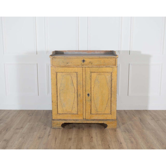 A rare Swedish Gustavian period buffet, late 18th century, retaining its original yellow-painted surface with beautifully...