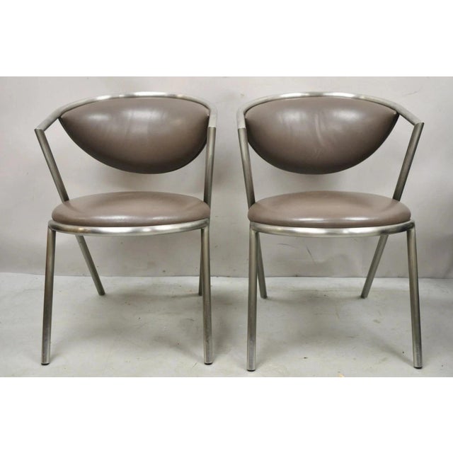Vintage Brueton Mid Century Modern Tubular Steel Cat Eye Lounge Chairs - a Pair. Item features brushed stainless steel...