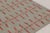 Handwoven in wool and natural yarns, this 9x12 Scandinavian rug has a soft sage field with delicate coral geometric...