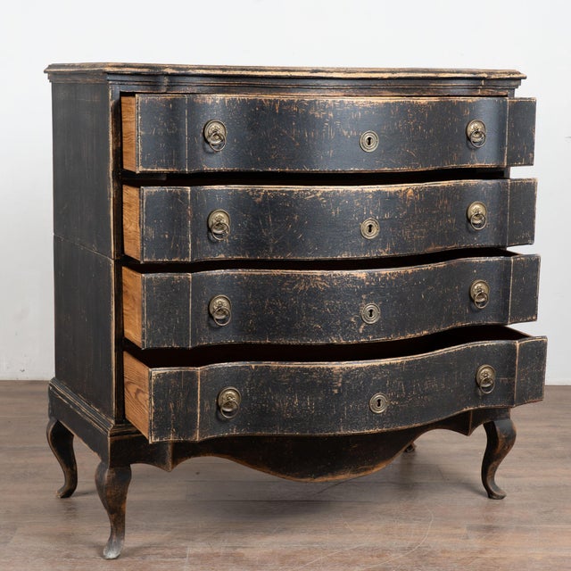 The black painted finish is striking in this attractive large oak chest of four drawers resting on carved skirt and curved...