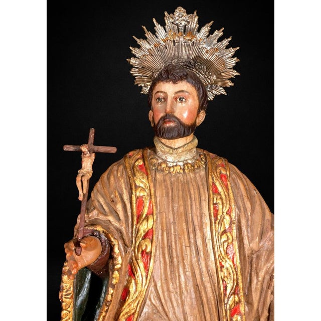 A striking 18th-century Spanish Colonial polychrome wood sculpture depicting Saint Francis Xavier, one of the most revered...