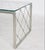 Elegant Hollywood Regency coffee table featuring a nickel-plated metal frame with an airy geometric lattice design and...