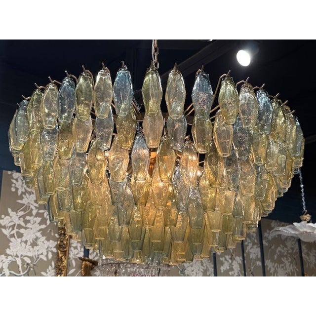 The Beautiful Tri-Color Poliheder Murano Glass Waterfall Chandelier is a lighting fixture. The chandelier is designed with...