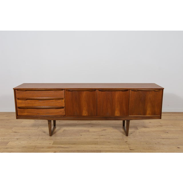 This teak sideboard was manufactured by the renowned British furniture maker Younger Ltd. in the 1960s. It is an excellent...
