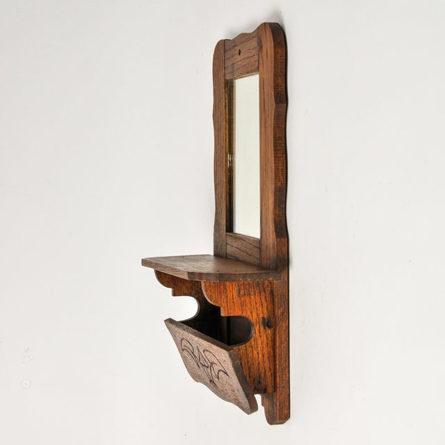 Adorable petite Victorian shaving mirror in a nice dark finish with a shelf small cubby below for storing necessities....
