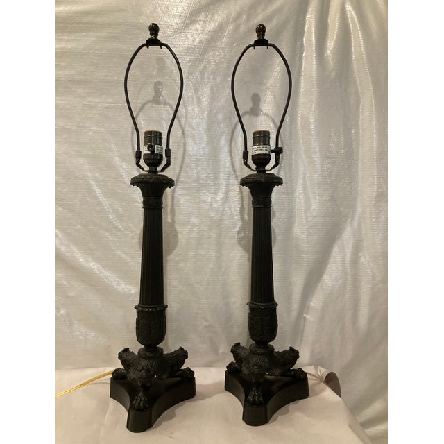 Vaughan Solid Bronze table lamps. Lamps have a fluted bronze stem resting on a tripod footed base.