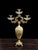 DIMENSIONS Height: 19 inches This luxurious three-arm candle holder showcases elaborate scrollwork inspired by classic...