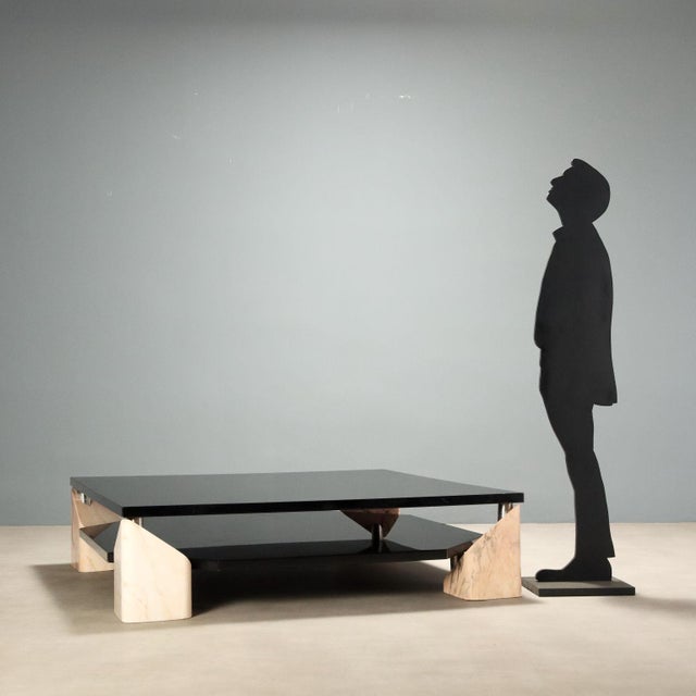 Vintage 1970s coffee table, characterized by a design that combines elegance and functionality. Made with a double black...