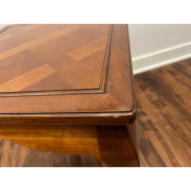 Heritage Henredon French Provincial Accent Side Table features a bookmatched cherry wood parquetry top, scalloped apron...