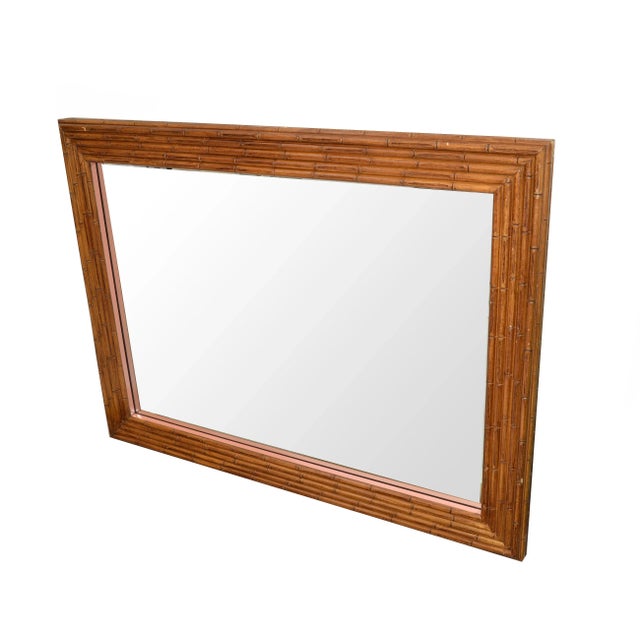 1950s large and heavy rectangular wall or dresser mirror made out of Bamboo. The mirror is very heavy and is supported by...