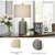 This contemporary ceramic table lamp features a sculptural white base with a smooth, glossy finish, paired with a soft...