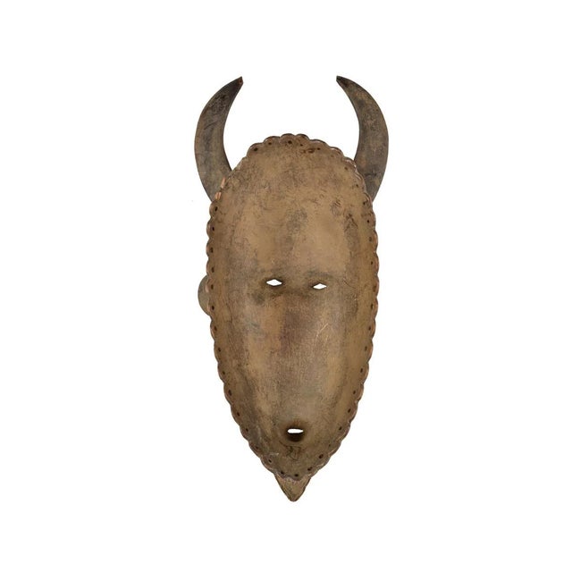 The Senufo Kpelie wood mask is a significant cultural artifact originating from the Senufo people of CÃ´te d'Ivoire, a...