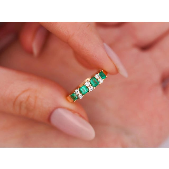 1 carat total natural emerald and diamond band ring in 14k solid yellow gold. The emeralds are rich with color, a vivid...