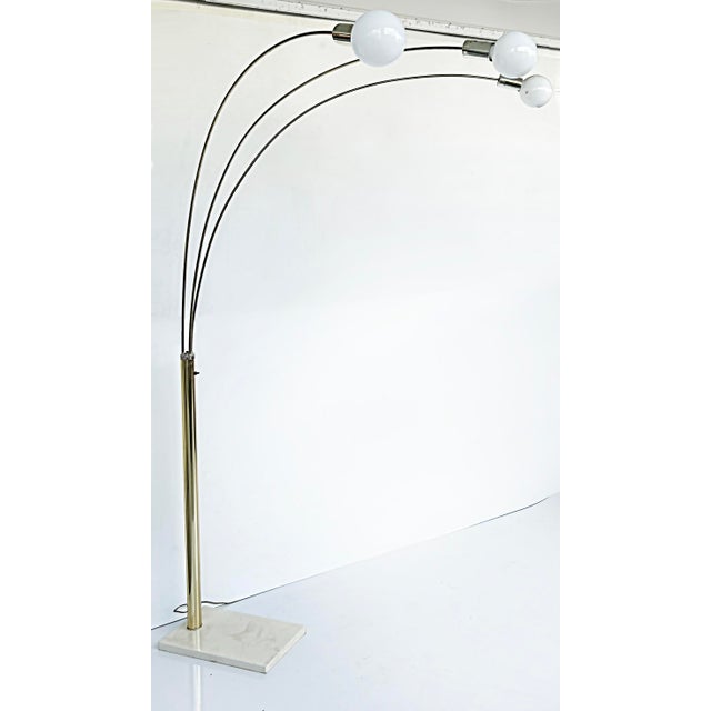 Mid-century Modern Brass Arched Floor Lamp, Marble Base Offered for sale is a recent acquisition from a Miami Beach...
