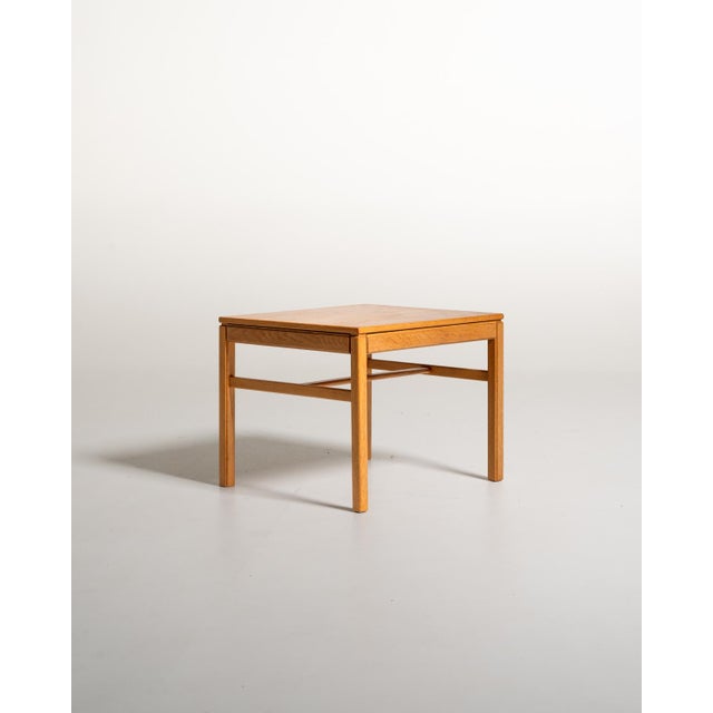Oak frame with geometric lines, a square top, straight legs, and thin connecting crosspieces. Designed by Sven Engström...