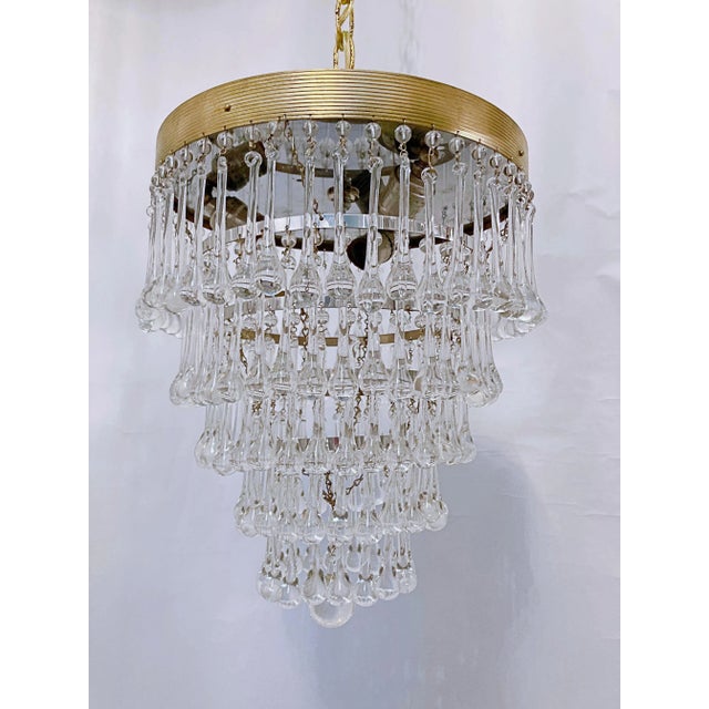 Italian layered chandelier with decorative gold rim, plain beads and hand blown teardrops. It has 6 layers of crystals and...