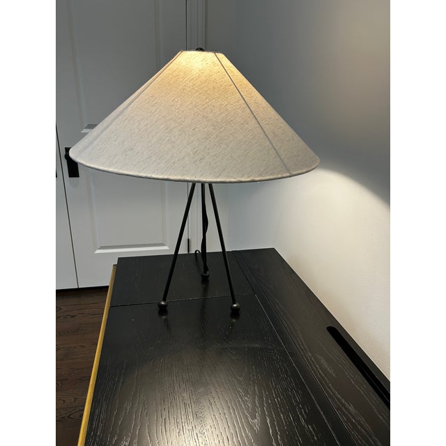 A slim, sculptural tripod table lamp from Lulu and Georgia's Colbeck collection. Iron legs in a black finish add dimension...
