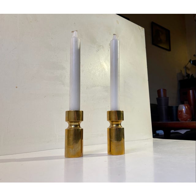 A pair of small yet heavy candle holders composed of engine-turned solid bronze. Their are to be installed with regular...