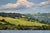 In "Loch Side," a serene landscape unfolds, showcasing rolling green hills that gently slope towards a tranquil body of...