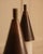 A striking pair of vintage italian wall sconces, circa 1970s, in dark brown metal and opaque white glass. featuring...
