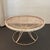 This classic Mid-Century Modern outdoor coffee table showcases a sculpted wire-hoop pedestal base supporting a signature...